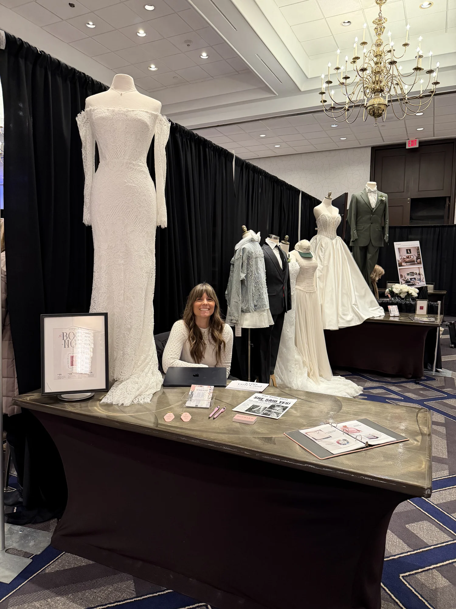 Bridal boutique booth with wedding gown mannequins and styling