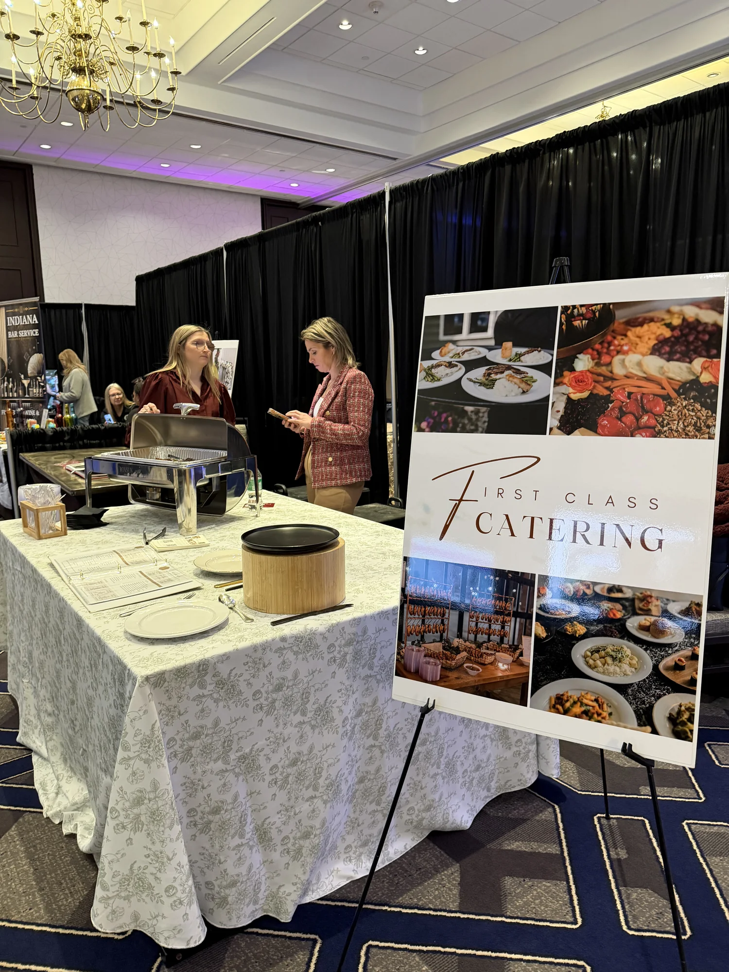 First Class Catering booth with menu display and serving staff