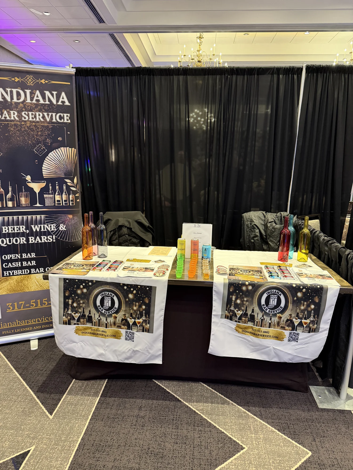 Indiana Bar Service booth with bar menu banner and bottle display