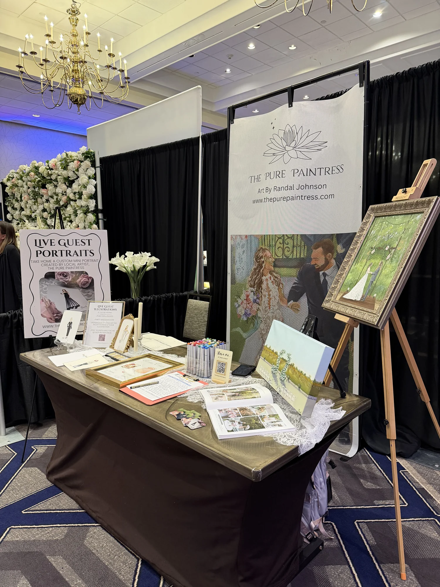 The Pure Paintress booth offering live guest portraits